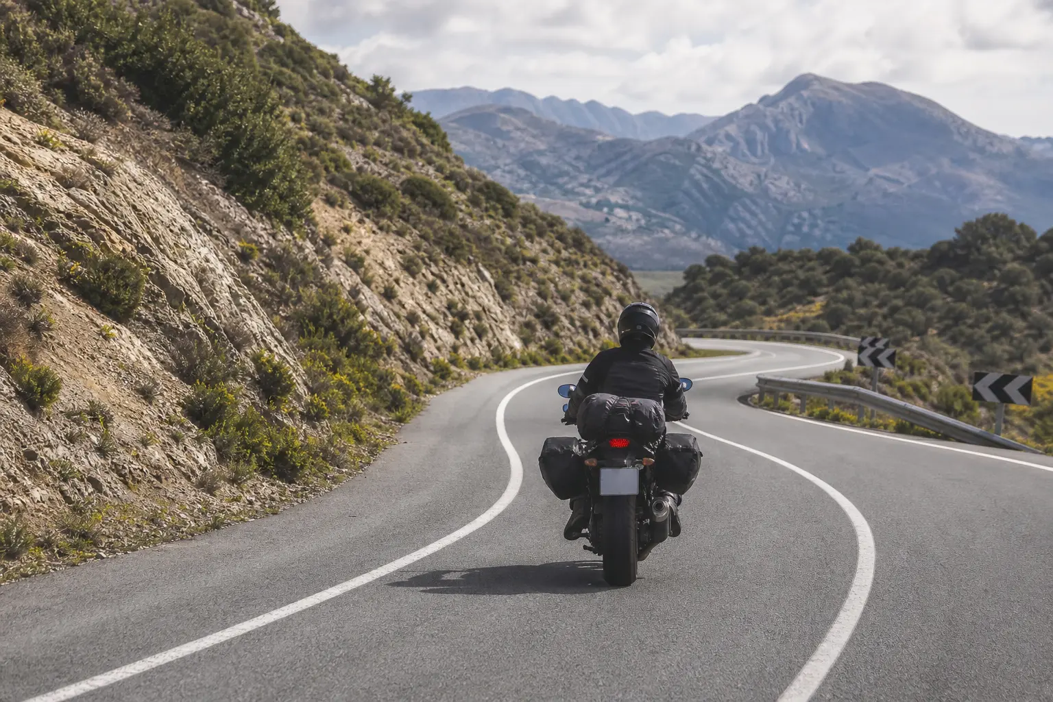 Rider scanning through a rural motorcycle curve.