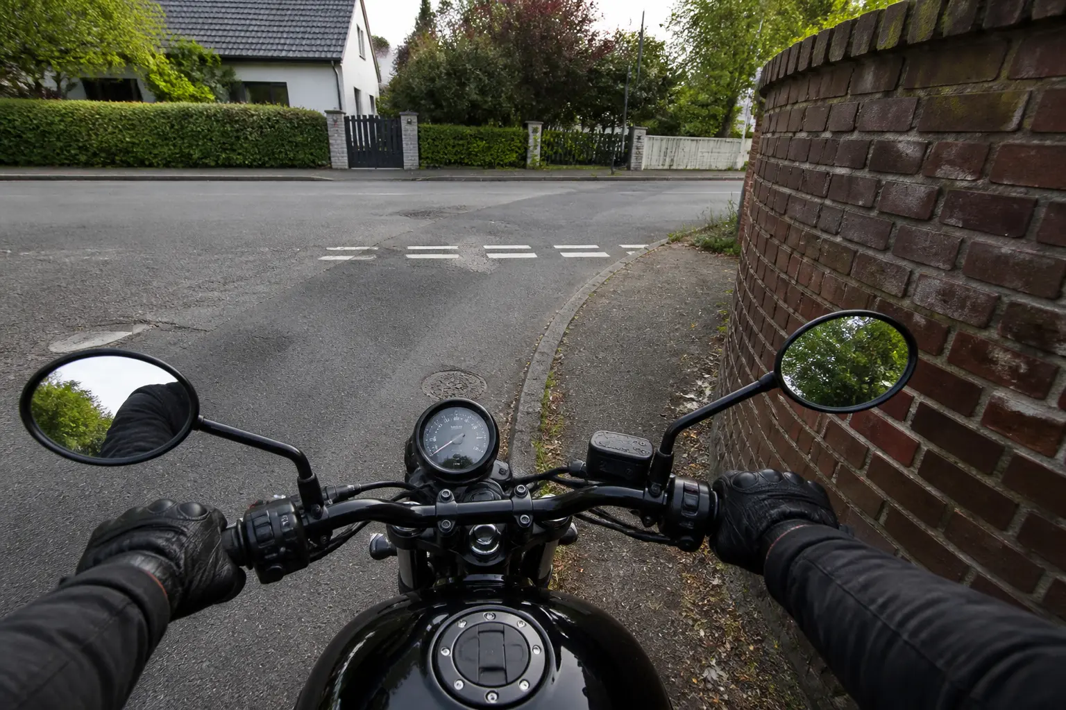 Motorcycle paused at a blind residential corner