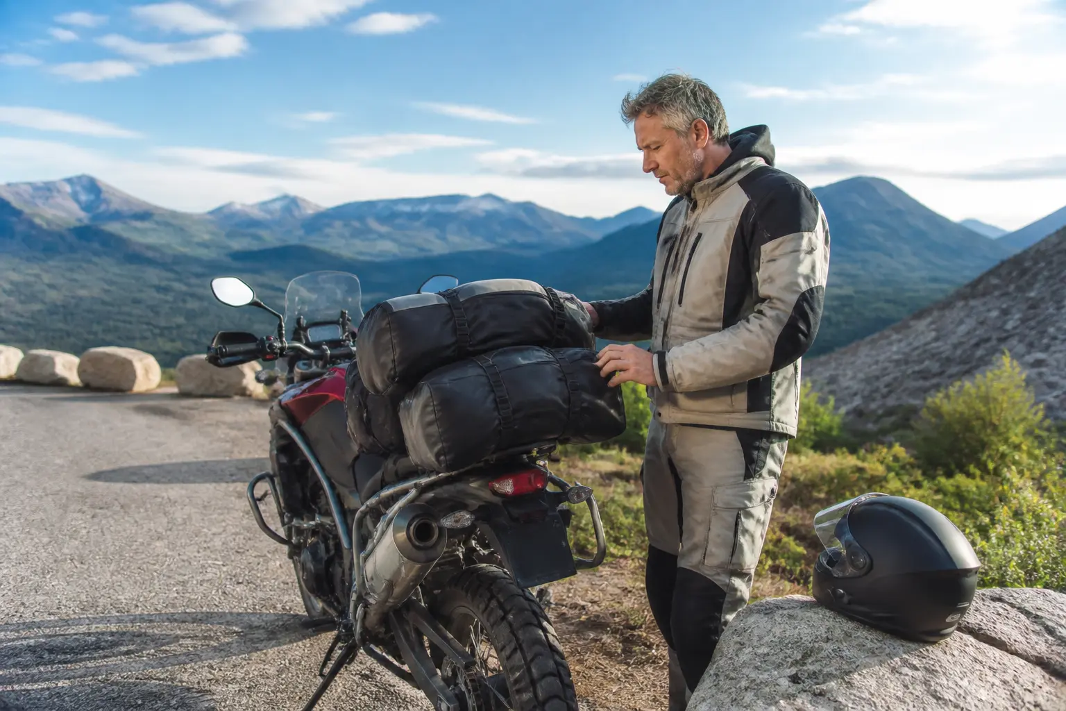 Motorcyclist checks luggage security during a shakedown ride