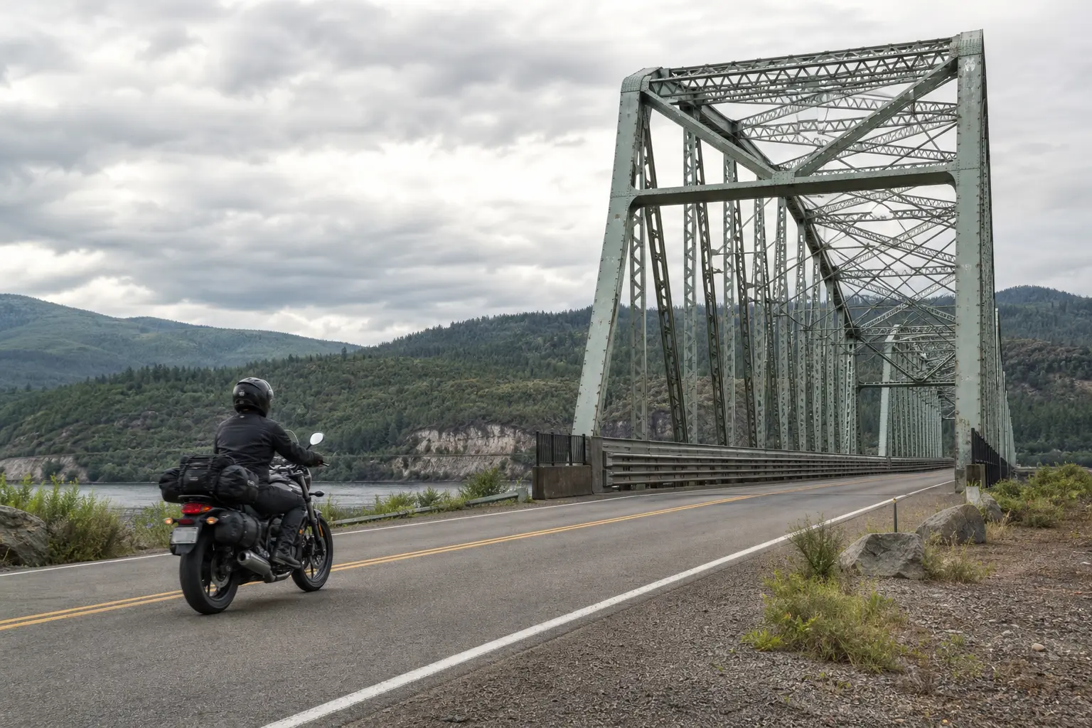 Motorcyclist approaching a steel bridge deck with a clear view ahead