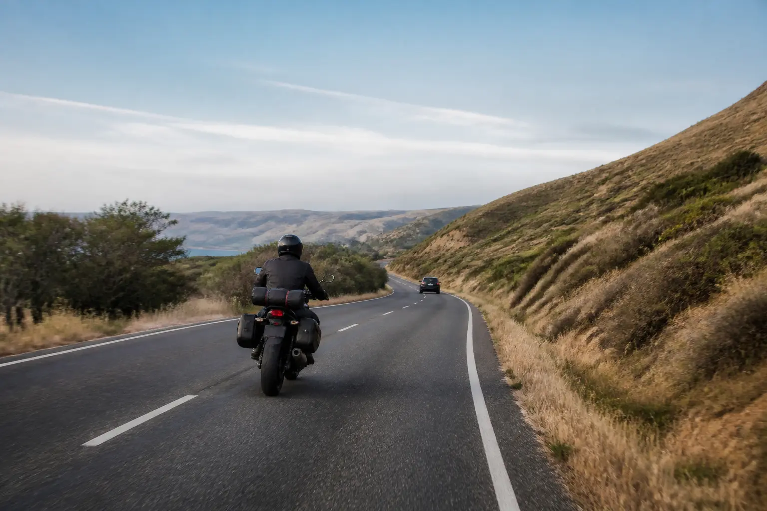 Motorcyclist preserving following distance and scanning for open space in traffic