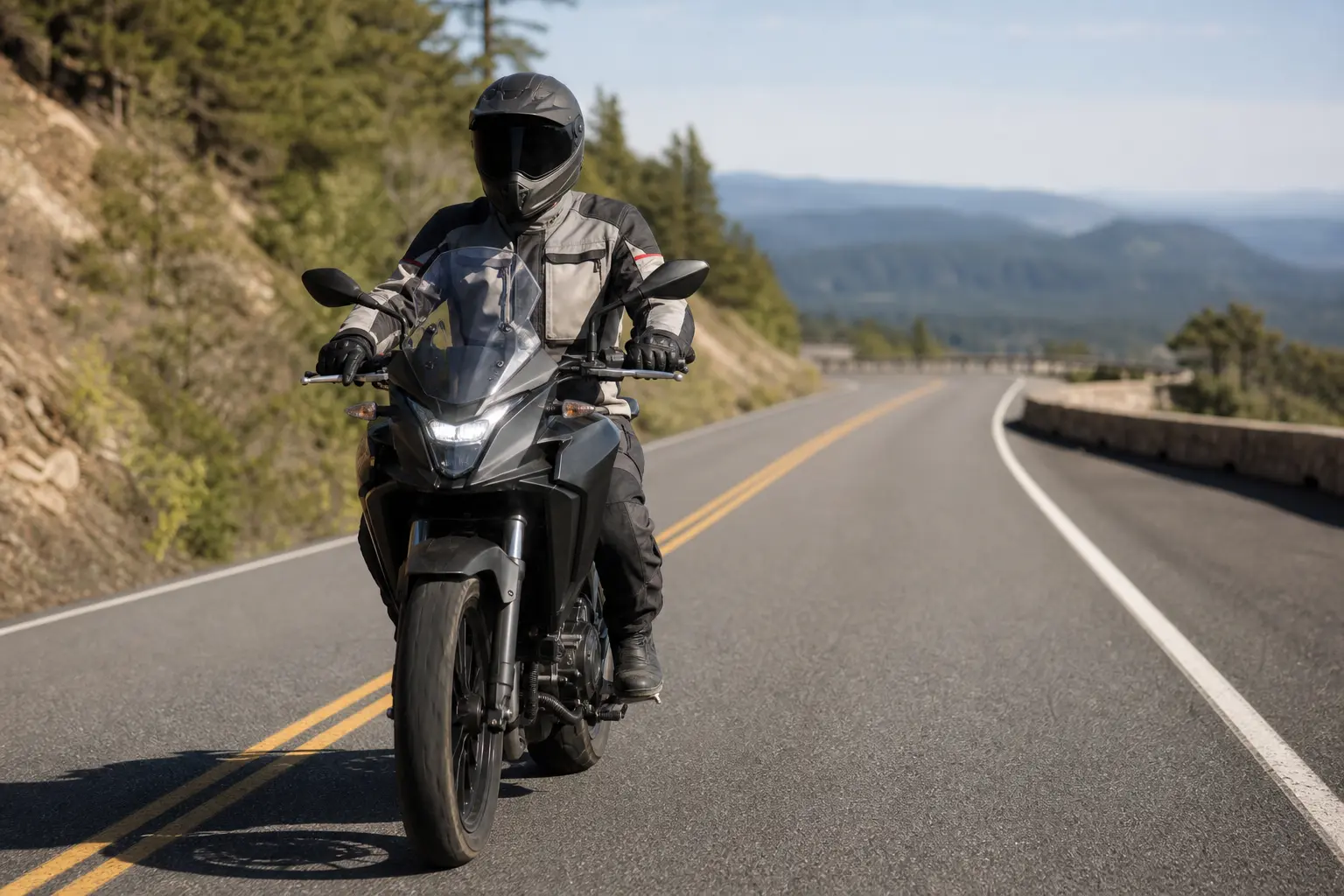 Motorcyclist riding steadily on an open road with room to slow safely.