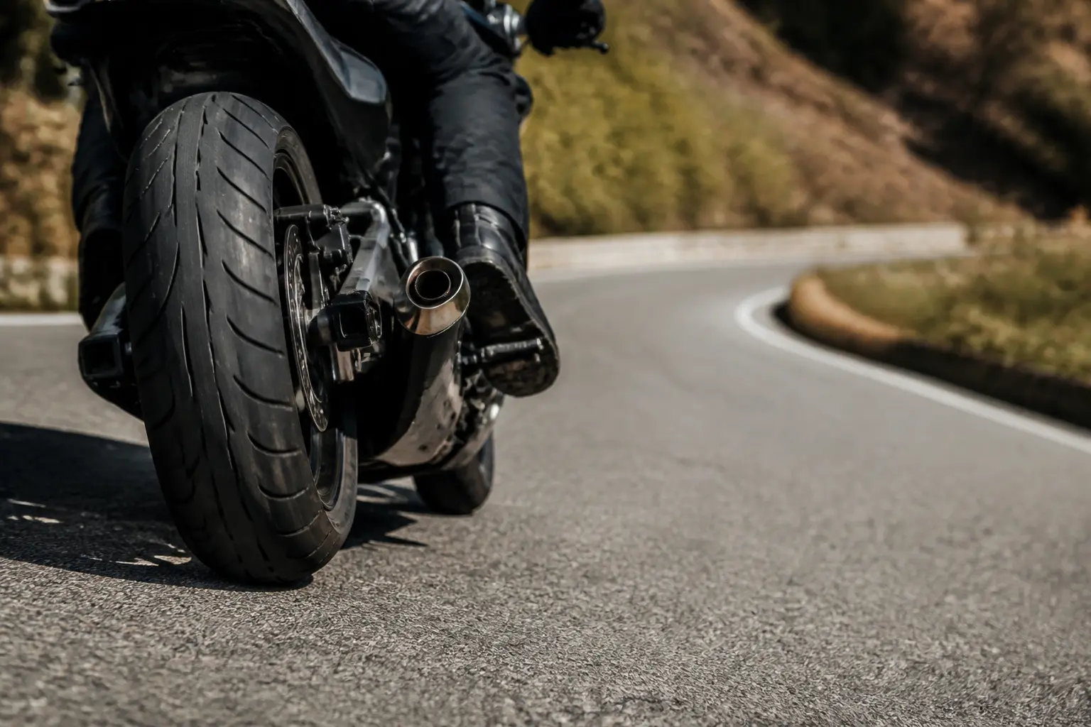 Generic motorcycle tire meeting textured pavement in a curve