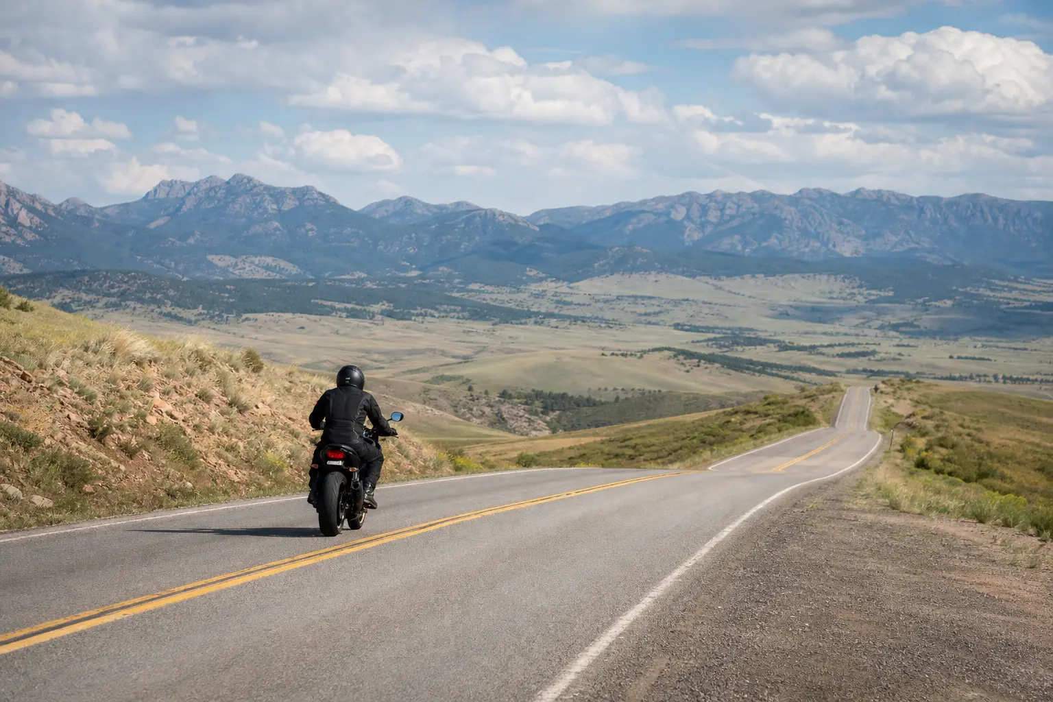 Motorcyclist assessing open road space before a pass